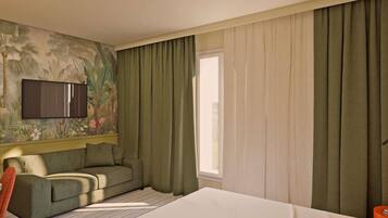 A hotel room with a bed, a sofa, a TV mounted on the wall, and a window with curtains.