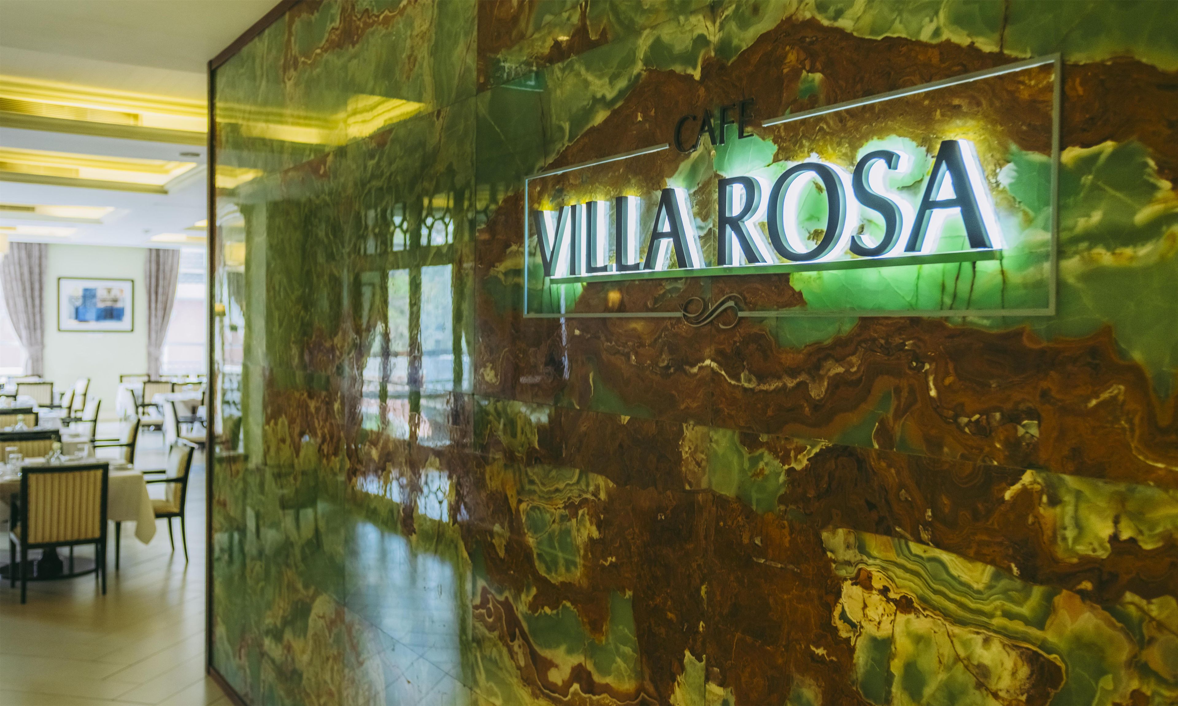 A marble wall with a sign reading 'Villa Rosa'.