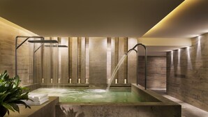 A modern spa with a rectangular hot tub, multiple showerheads, and candles on the walls. - Grand Hyatt Shenyang (Shenyang)