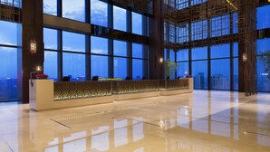 A spacious lobby with a reception desk, large windows, and a high ceiling. - Grand Hyatt Shenyang (Shenyang)