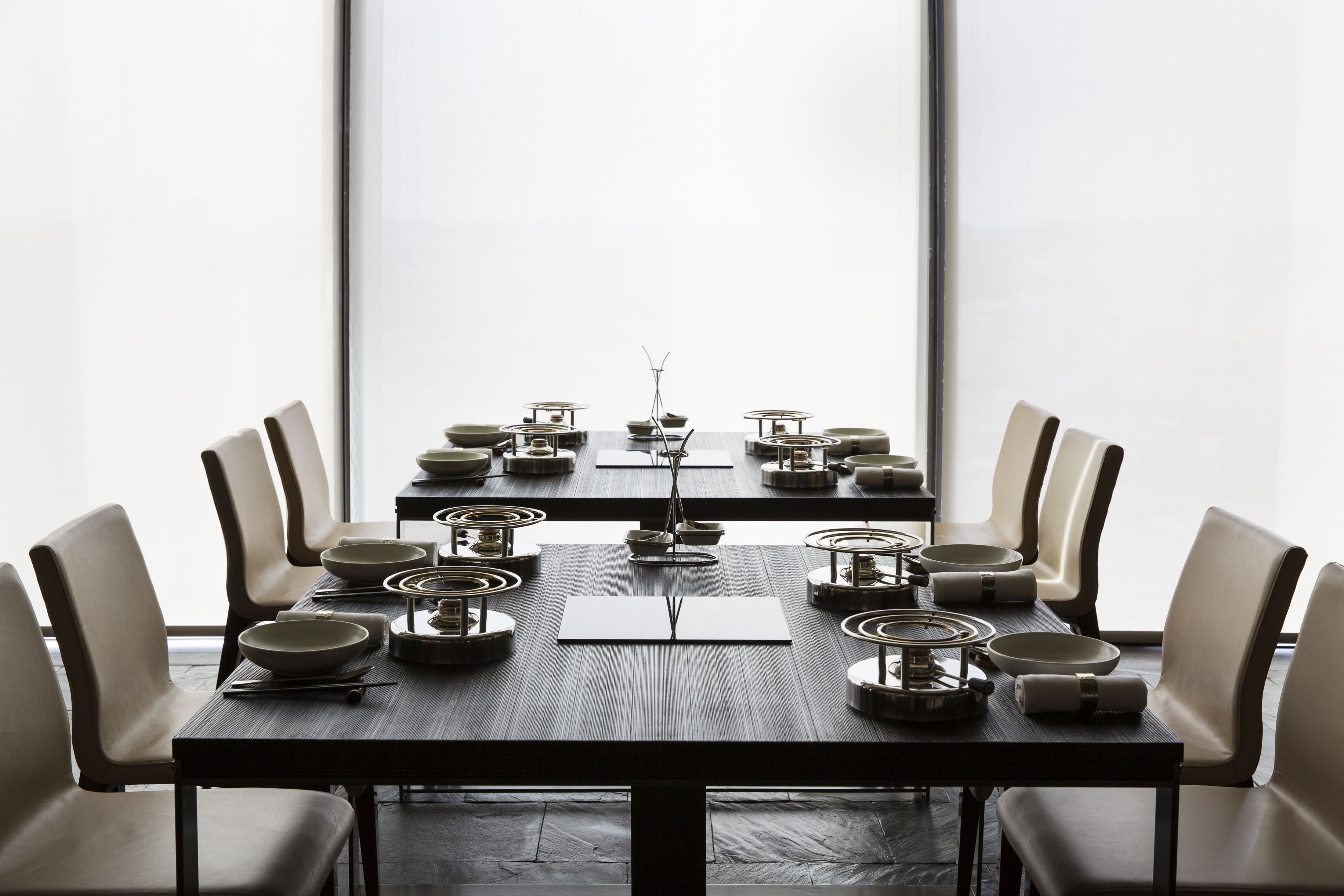 Mesa de jantar posta para seis lugares, com design moderno, rodeada por seis cadeiras.