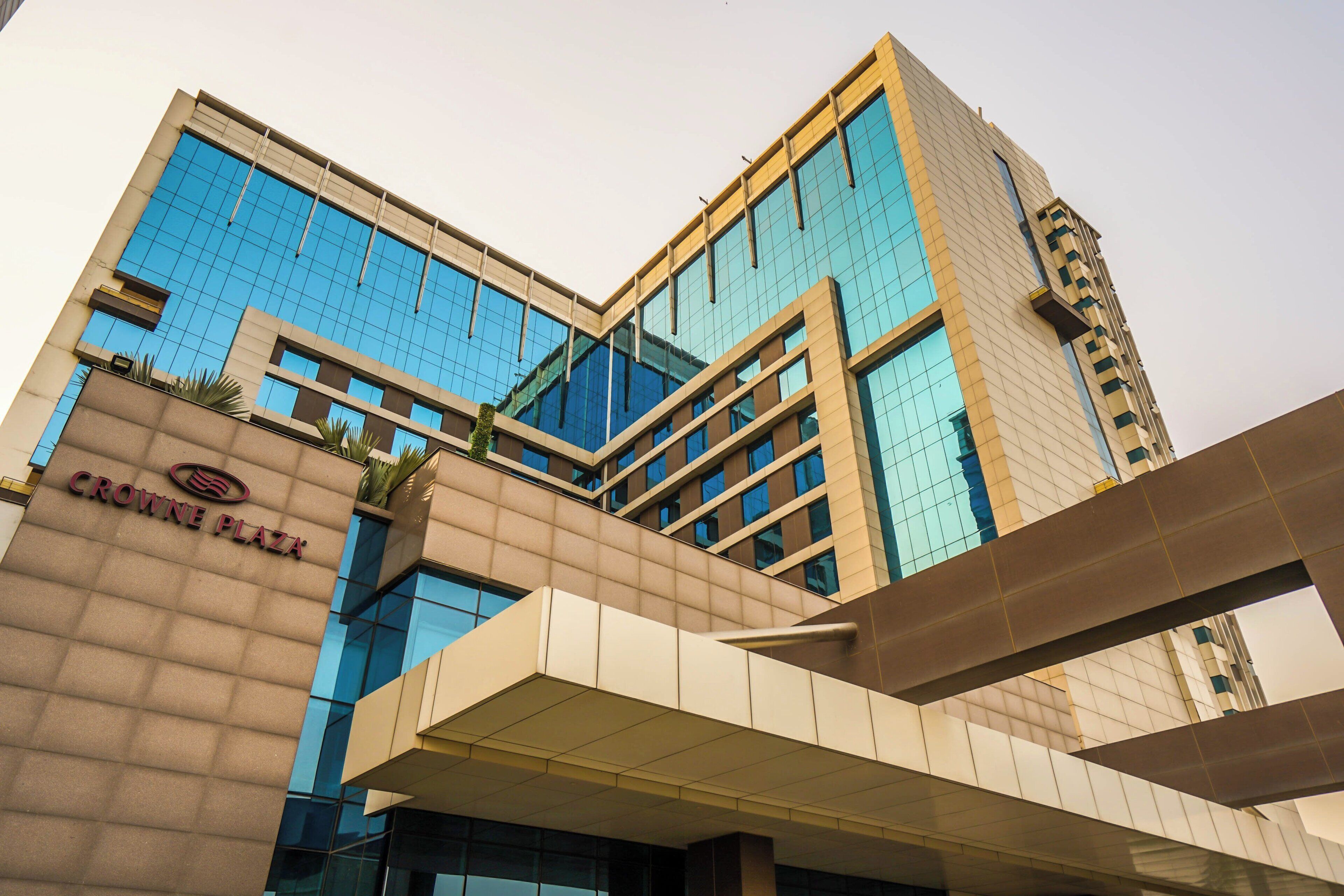 A modern building with a prominent sign reading 'CROWNE PLAZA'.