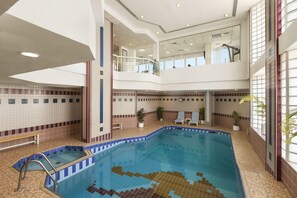 Indoor pool, pool loungers - Ramada by Wyndham Beach Hotel Ajman (Ajman)