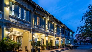 A two-story building with a ground-floor cafe and upper-floor rooms. - The Columns (Kampot)