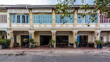 Traditional buildings with flat roofs, balconies, and shutters line the street.
