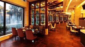 A restaurant with a wooden floor, large windows, and a high ceiling with exposed beams. - Shandong Hotel (Jinan)