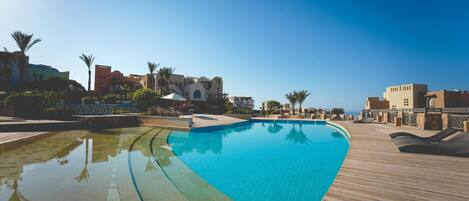 7 outdoor pools, open 8:00 AM to 10:00 PM, pool umbrellas