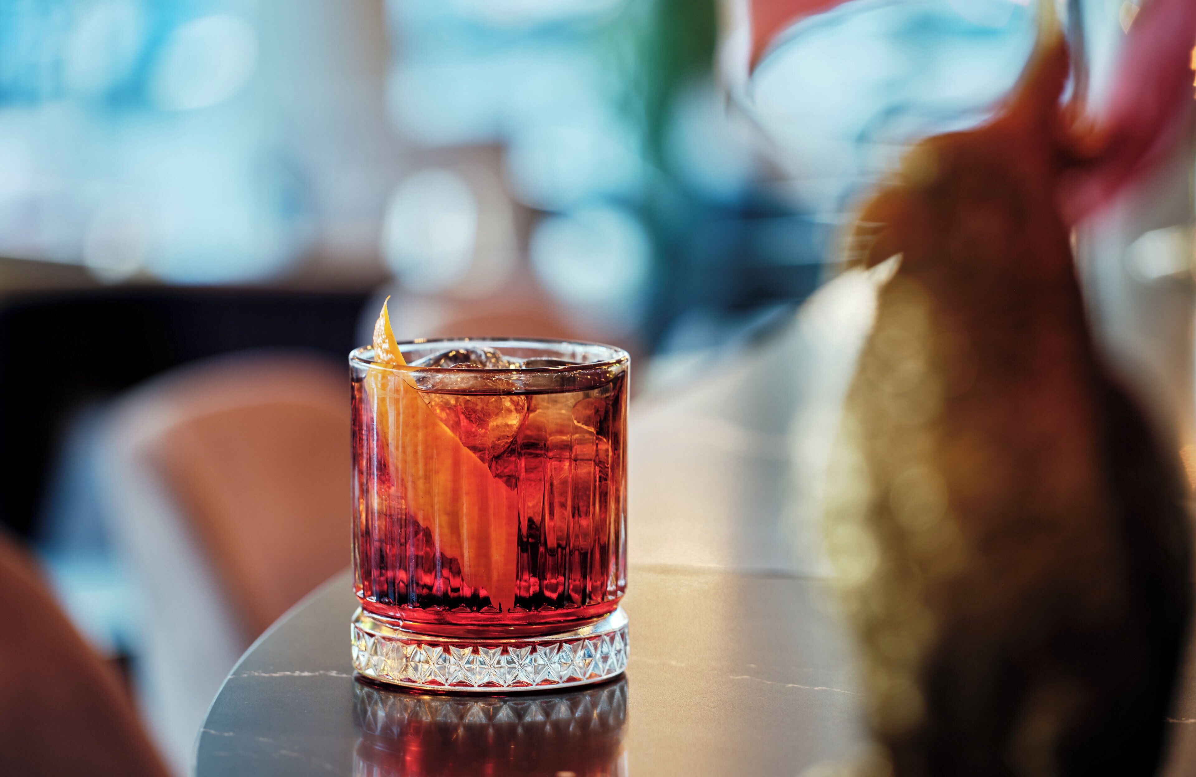 A glass with a drink on a table.