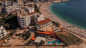 An aerial view of a coastal hotel with multiple buildings, a beach, and a swimming pool. - David Dobre Vode (Bar)
