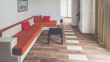 Comfort Quadruple Room, Sea View | Living room | Flat-screen TV