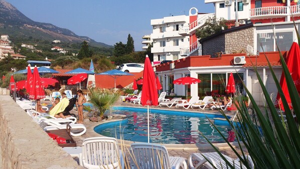 Seasonal outdoor pool, open 10:00 AM to 7:00 PM, pool umbrellas