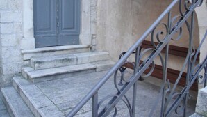 A stone staircase leading to a door with a metal railing. - B&B Central Palace Heritage (Split)