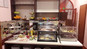 A buffet setup with various food items and condiments. - B&B Central Palace Heritage (Split)