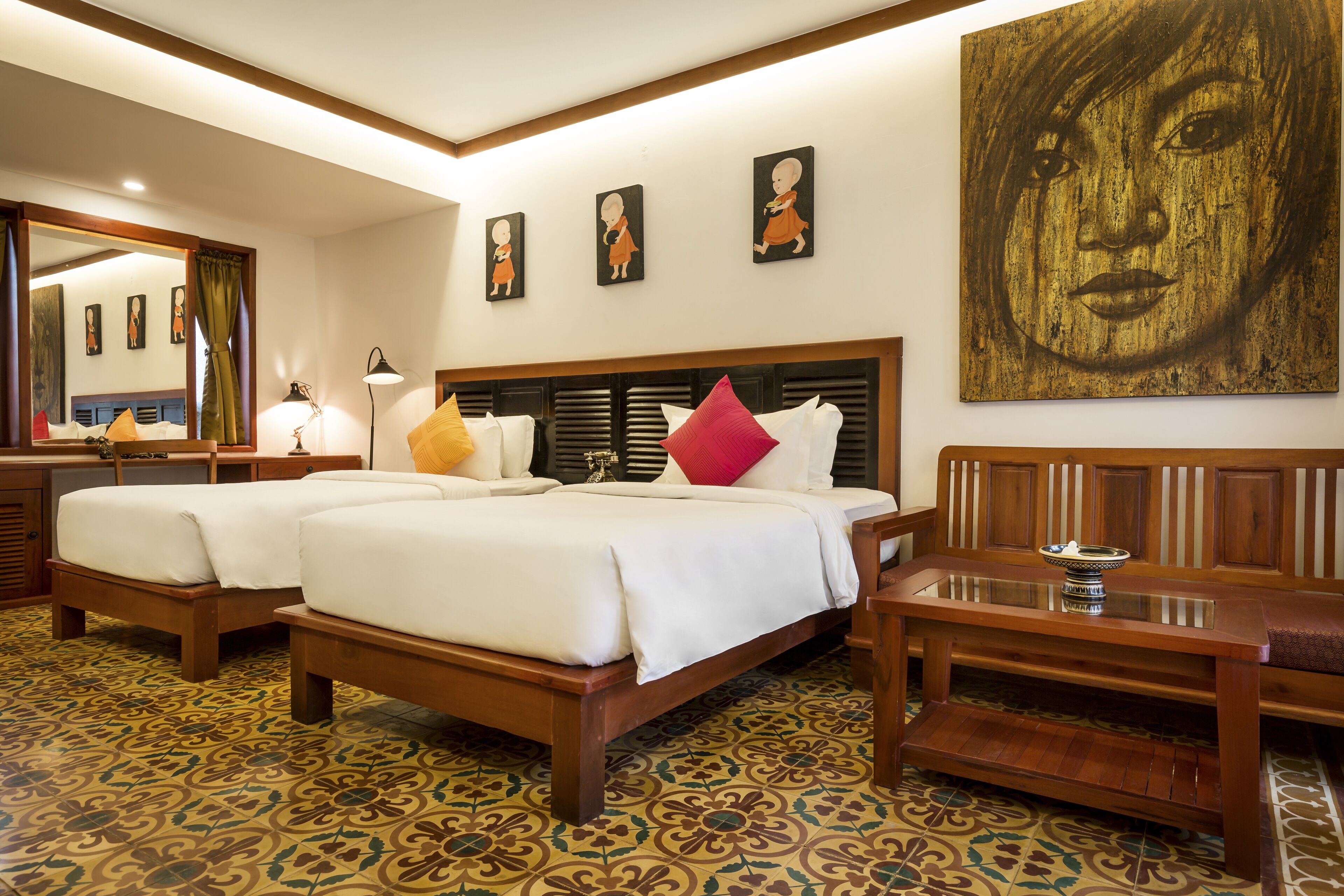 A hotel room with two beds, a wooden headboard, a large mirror, and a patterned floor.