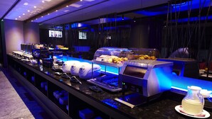 A buffet setup with various food items and serving equipment. - The Tango Taipei ChangAn (Taipei)