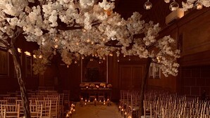 An indoor venue with rows of wooden chairs and a central aisle. - Abbey House Hotel (Barrow-in-Furness)
