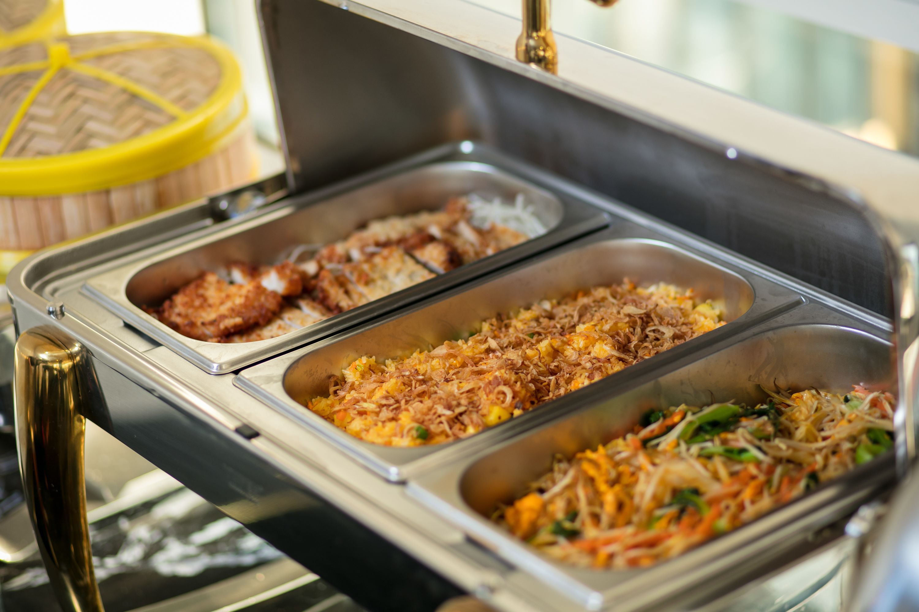 Un buffet proposant une variété de plats, notamment des plats frits, du riz et des légumes.