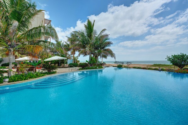 2 outdoor pools, open 7 AM to 7 PM, pool umbrellas, pool loungers