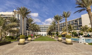 A hotel with a central courtyard, palm trees, and a swimming pool. - Crowne Plaza Duqm by IHG (Duqm)
