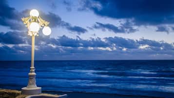 A coastal scene with a street lamp and ocean view.