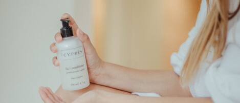 A person holding a bottle of Cyprus lotion.
