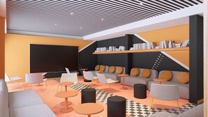 A modern lounge area with a large blackboard, bookshelves, sofas, and round tables. - ibis Styles La Rochelle Centre les Minimes (La Rochelle)