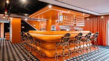 A bar area with a checkered floor, bar stools, and a bar counter with a glass display.