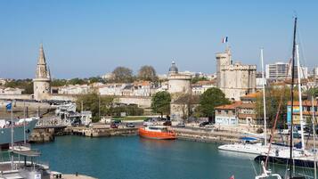 A harbor with boats, a castle, and a church.