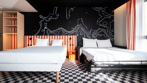 A modern hotel room with two beds, a checkered floor, a black and white abstract wall art, and a wooden bookshelf. - ibis Styles La Rochelle Centre les Minimes (La Rochelle)