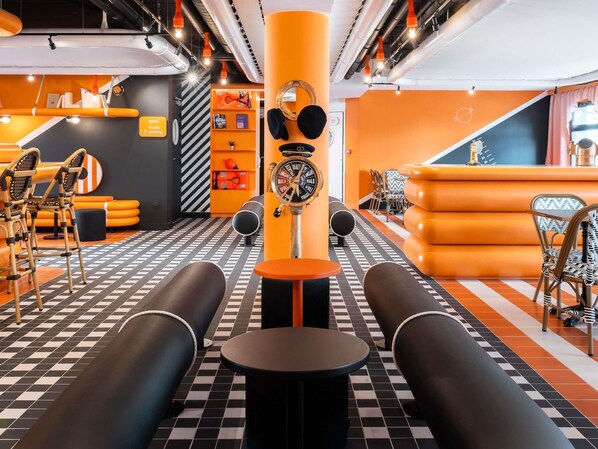 A modern interior with checkered flooring, a central pillar with a clock, and seating areas.