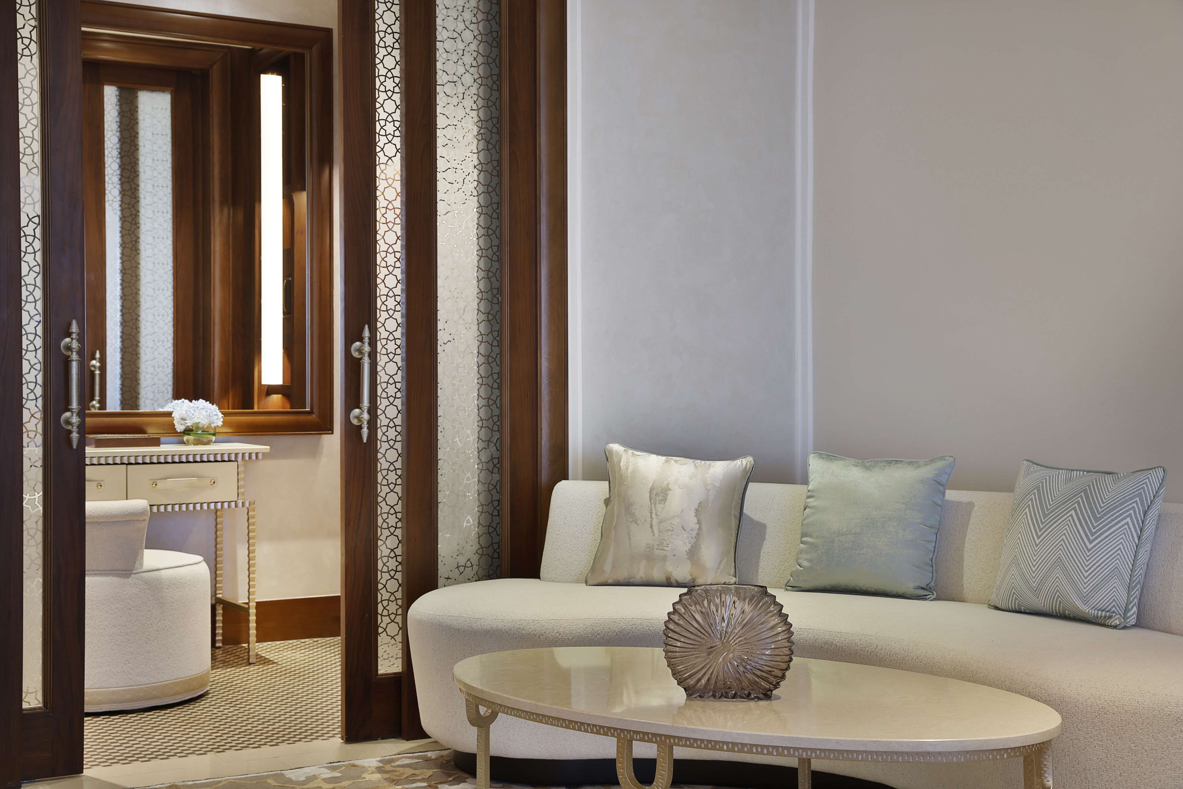 A modern living room with a sofa, a round coffee table, and a decorative vase.