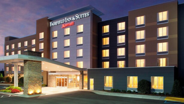 A multi-story hotel with a modern facade, a prominent entrance with a covered walkway, and a clear signage indicating it is a Marriott property.