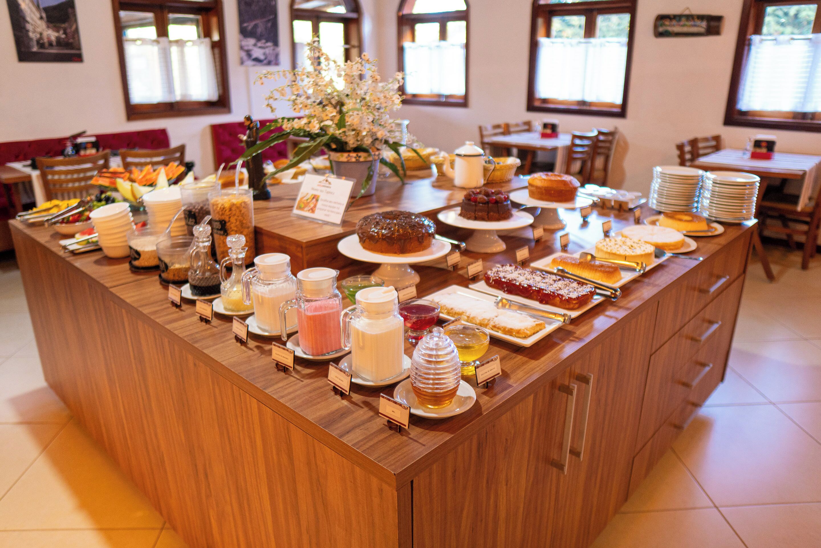 A buffet setup with various food items and beverages.