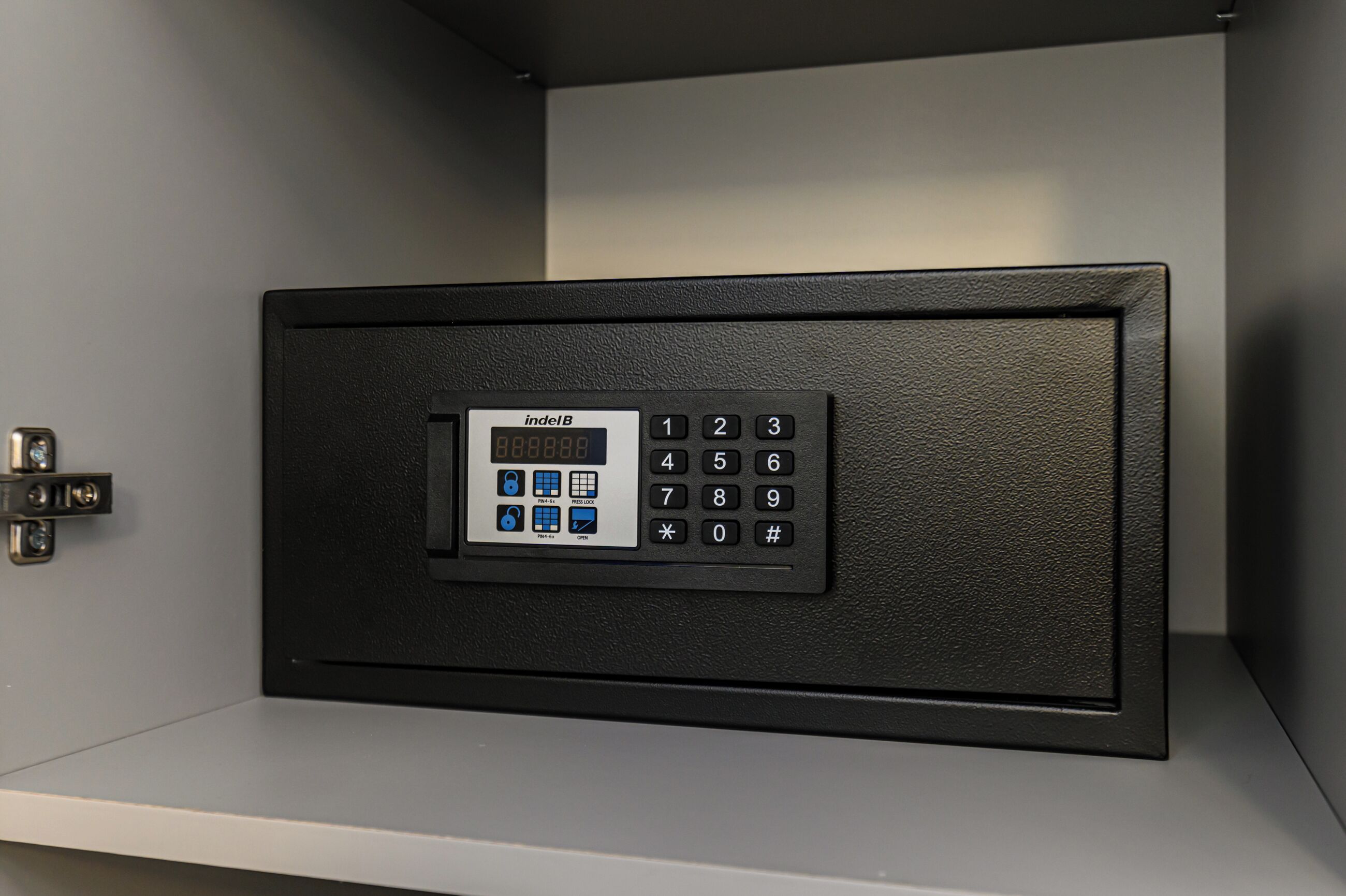 A black electronic keypad with a digital display and a numeric keypad.