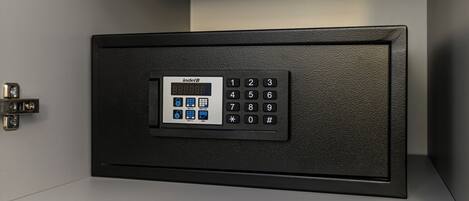 A black electronic keypad with a digital display and a numeric keypad.