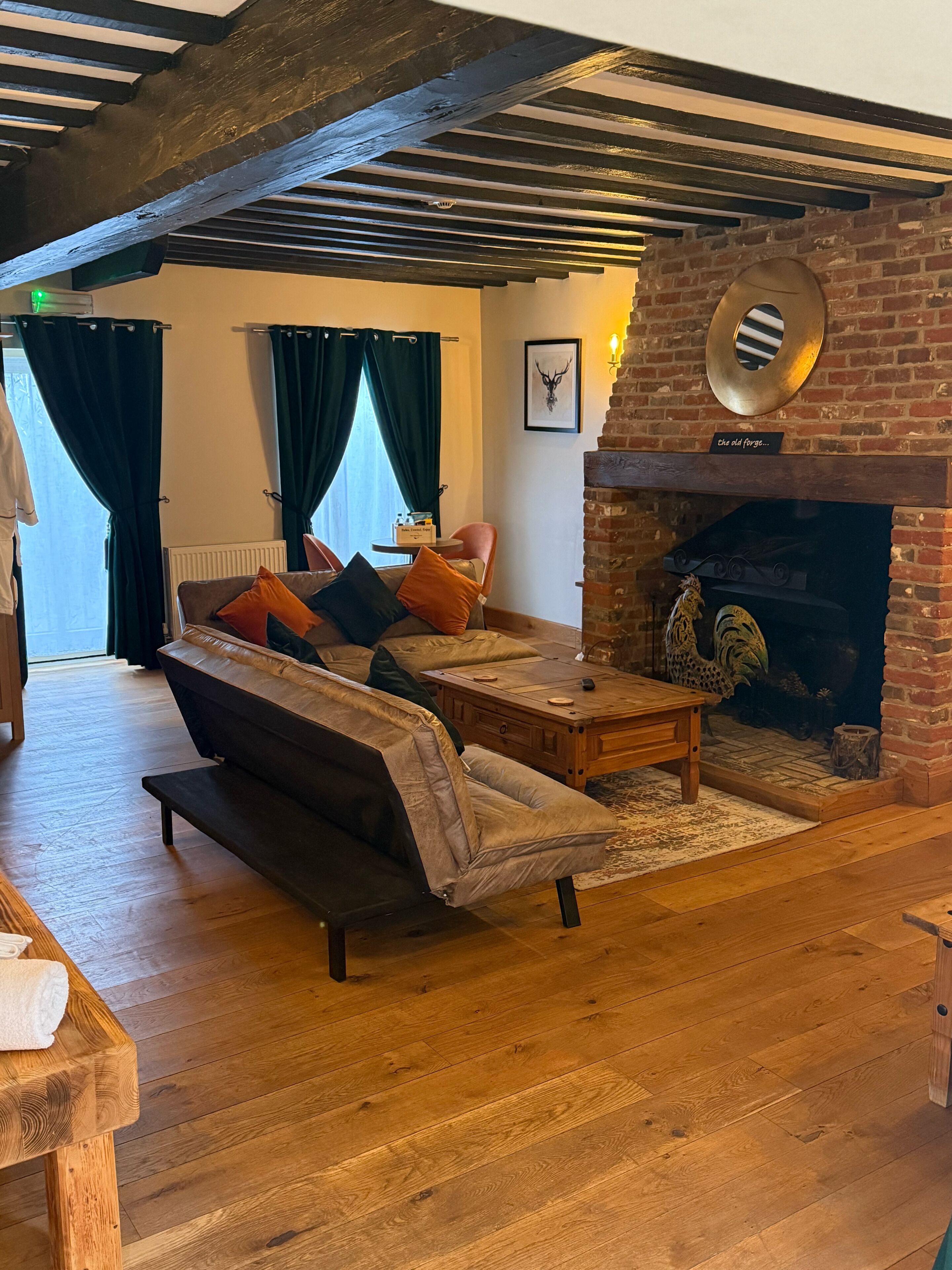 A cozy living room with a sofa, coffee table, and fireplace.