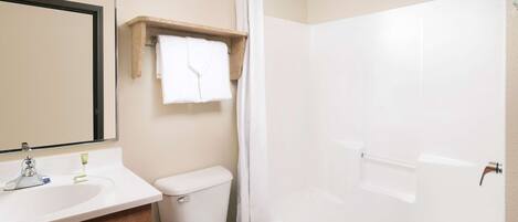 A bathroom with a toilet, sink, and bathtub.