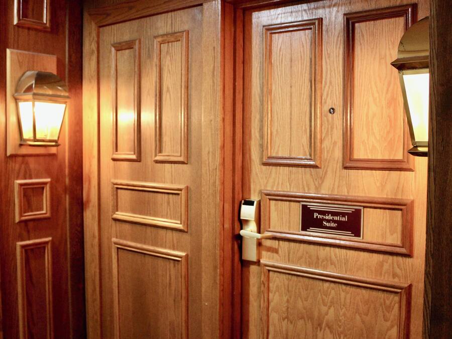 A wooden door with a sign reading "Presidential Suite".