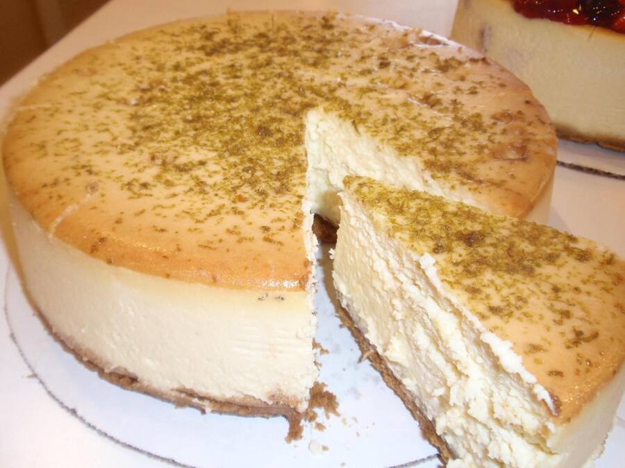 A cheesecake with a slice cut out.