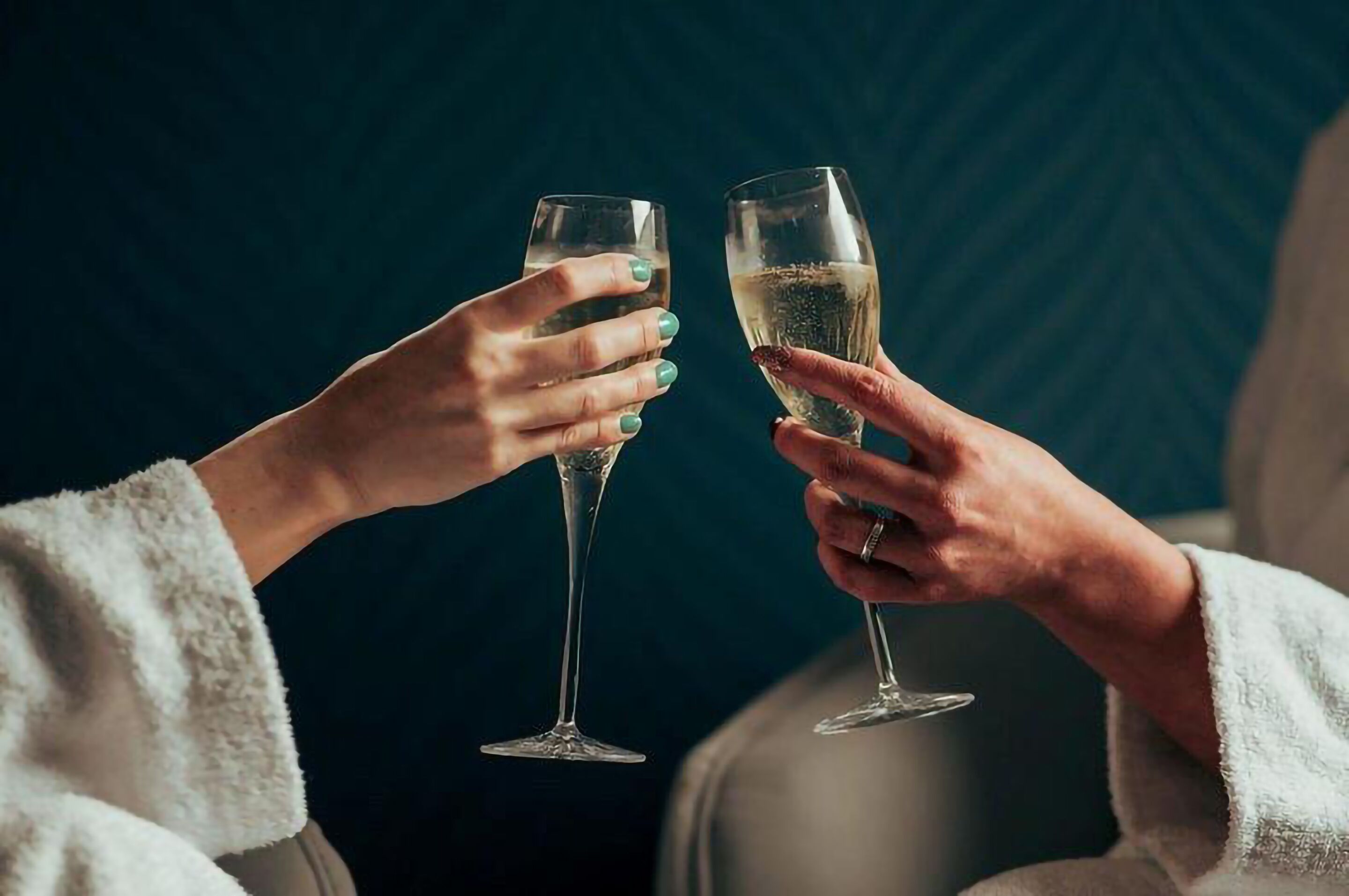 Two people toasting with champagne glasses.