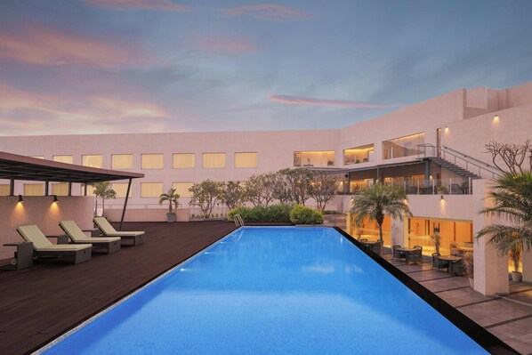 Outdoor pool, open 8:00 AM to 8:00 PM, pool umbrellas, pool loungers