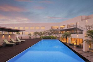 Outdoor pool, open 8:00 AM to 8:00 PM, pool umbrellas, pool loungers