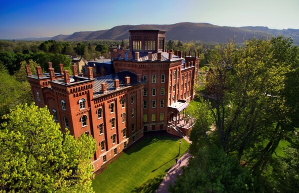 A large brick building with multiple towers and a central courtyard.