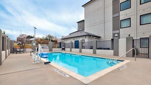 A rectangular swimming pool with a metal ladder, surrounded by a concrete deck. - Motel 6 Marble Falls, TX (Marble Falls)
