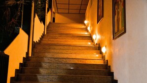 A staircase with handrails and wall-mounted lights. - Heritage Hotel (Anuradhapura)