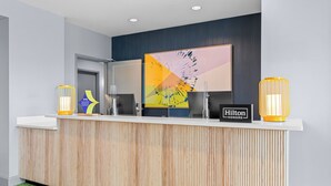 A reception desk with a wooden finish, two computer monitors, and a 'Hilton Honors' sign. - Spark by Hilton Victoria (Victoria)