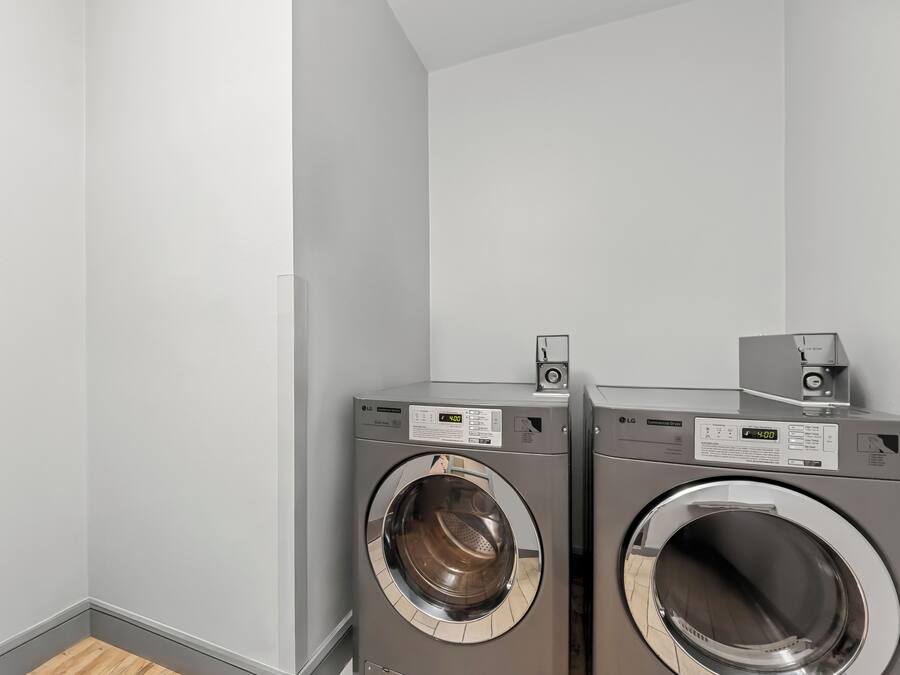 A laundry room with two front-loading washing machines.