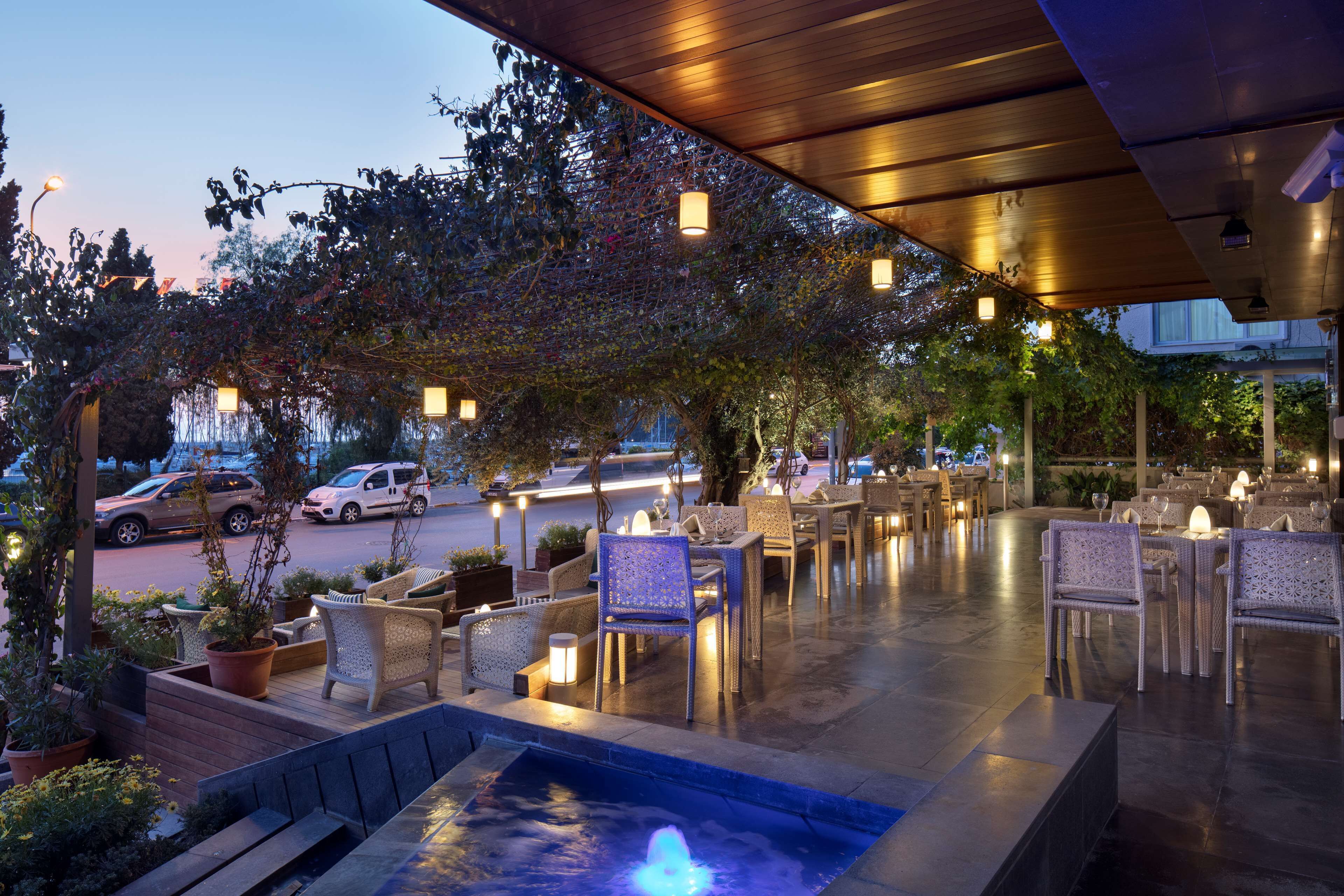 An outdoor patio area with seating and a water feature.