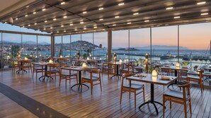 Un ristorante con vista sul porto e sullo skyline della città.