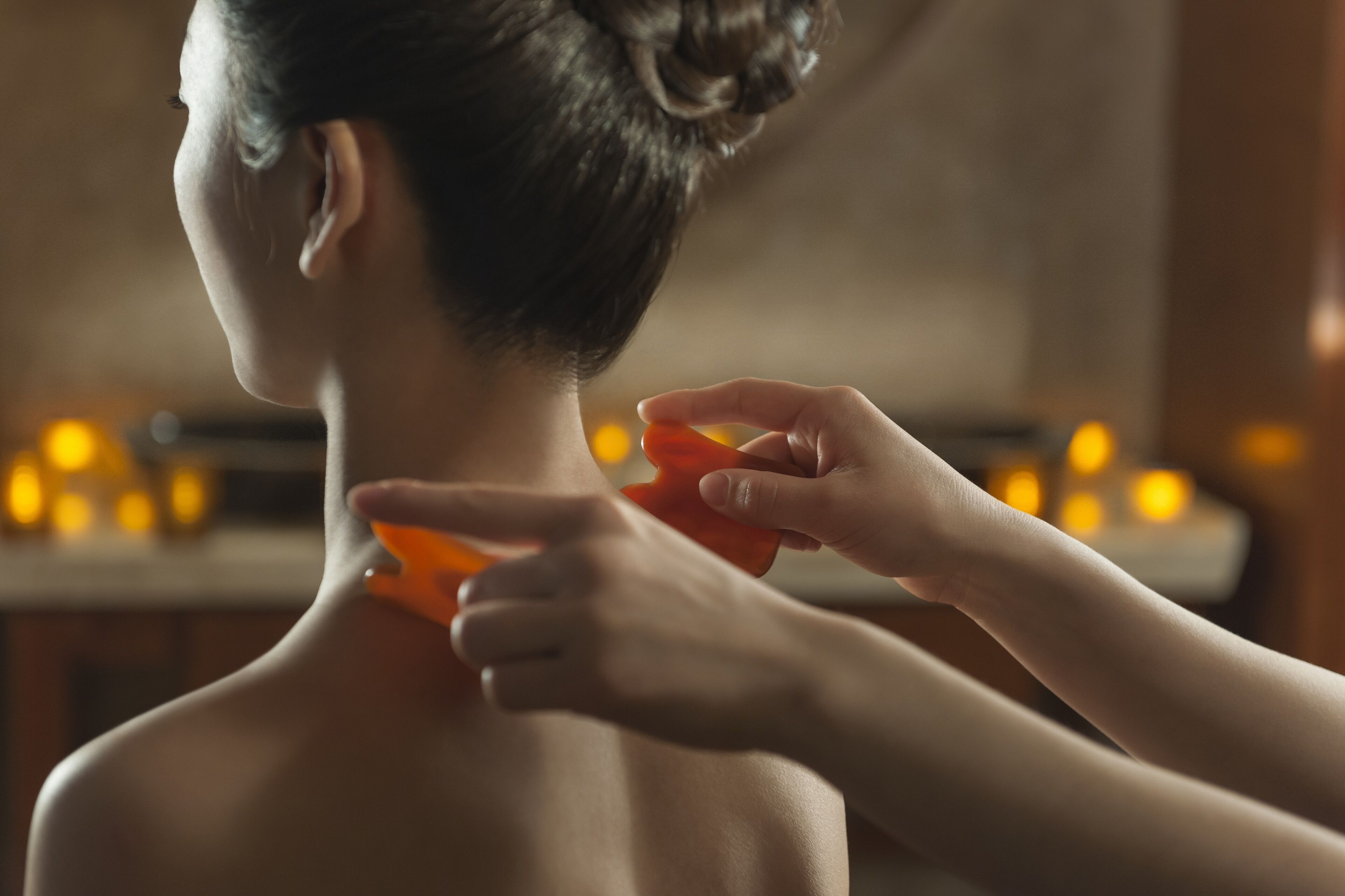 A person receiving a massage with a focus on the neck and shoulder area.
